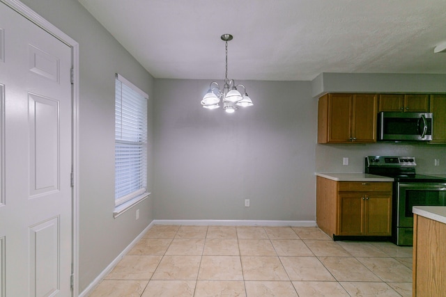 kitchen with an inviting chandelier, light countertops, appliances with stainless steel finishes, decorative light fixtures, and brown cabinetry