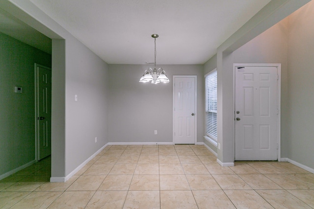 unfurnished room featuring light tile patterned floors, baseboards, and a notable chandelier