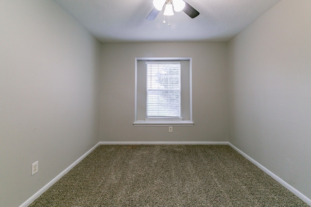 carpeted spare room with baseboards and ceiling fan