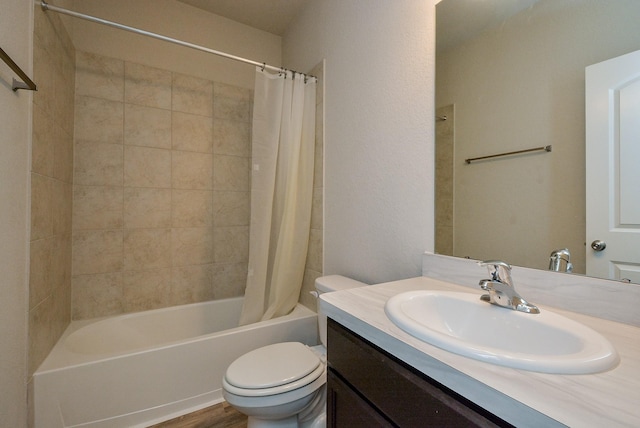 full bath with shower / bath combo, vanity, toilet, and wood finished floors