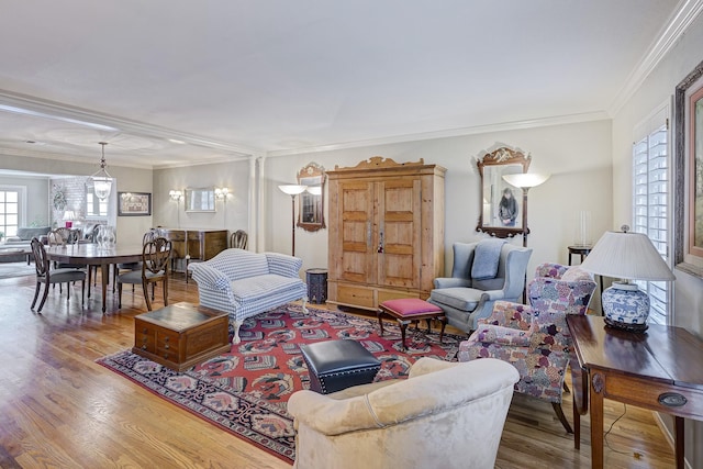 living area with crown molding and wood finished floors