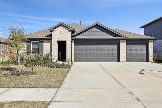 view of front of house featuring brick siding, a garage, roof with shingles, concrete driveway, and a front yard