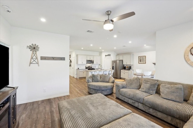 living area with recessed lighting, ceiling fan, visible vents, and light wood-style floors