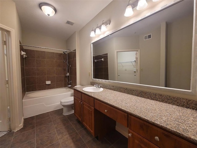 bathroom with toilet, vanity, visible vents, and tile patterned floors