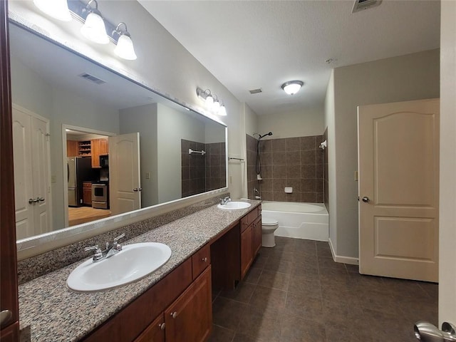 full bathroom featuring shower / bathing tub combination, a sink, visible vents, and tile patterned floors