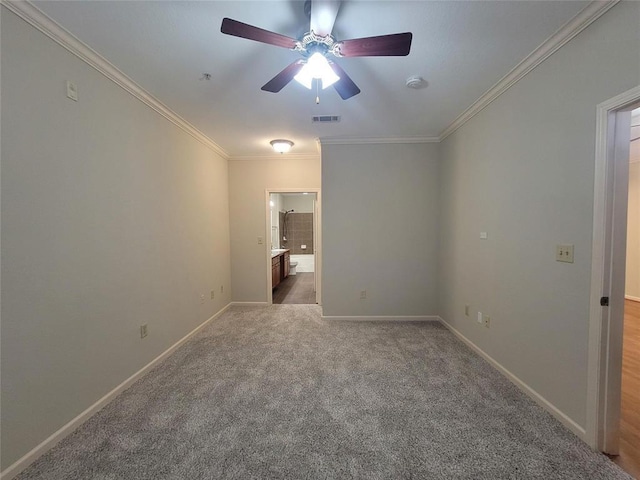 spare room with baseboards, visible vents, light colored carpet, ceiling fan, and ornamental molding