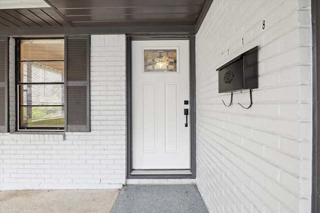 property entrance with brick siding