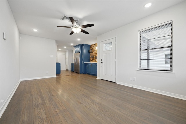 unfurnished living room featuring visible vents, baseboards, dark wood-style floors, ceiling fan, and recessed lighting