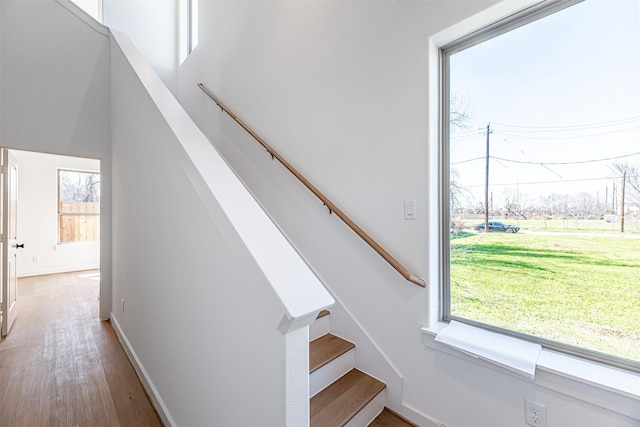 stairs with baseboards and wood finished floors