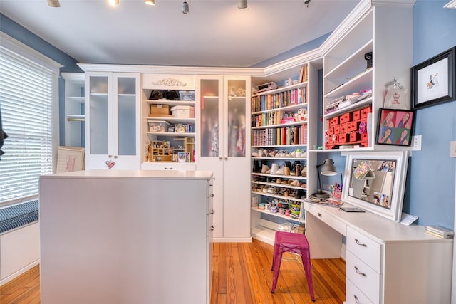 interior space featuring radiator heating unit, built in study area, and light wood finished floors