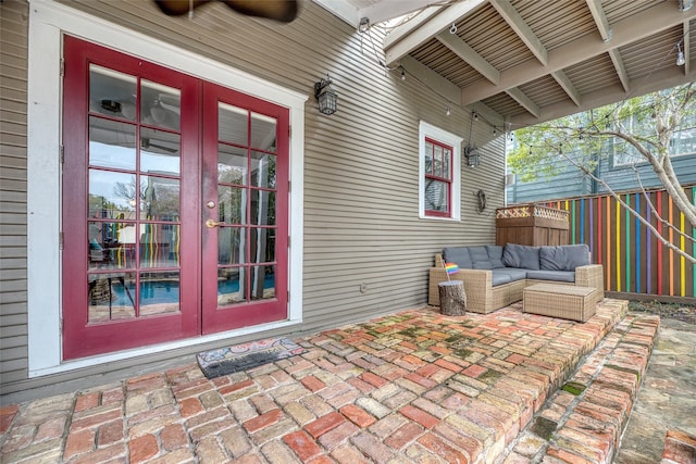 exterior space featuring ceiling fan, fence, french doors, a patio area, and an outdoor living space