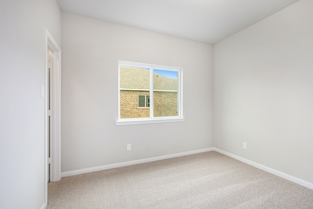 unfurnished room featuring carpet floors and baseboards