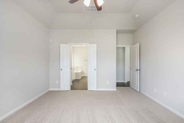 unfurnished bedroom with light carpet, visible vents, baseboards, ceiling fan, and vaulted ceiling