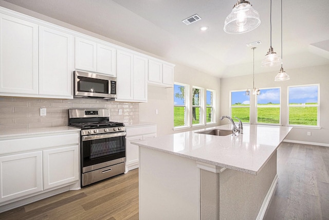 2102 Twin Lakes Blvd, West Columbia, TX 77486 - kitchen with appliances with stainless steel finishes, light wood finished floors, tasteful backsplash, white cabinets, and recessed lighting