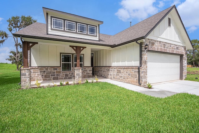 2102 Twin Lakes Blvd, West Columbia, TX 77486 - view of front of property featuring roof with shingles, stone siding, a front lawn, board and batten siding, and covered porch