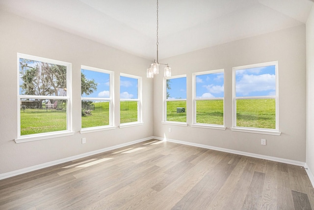 2102 Twin Lakes Blvd, West Columbia, TX 77486 - unfurnished room featuring a chandelier, light wood-style floors, and plenty of natural light