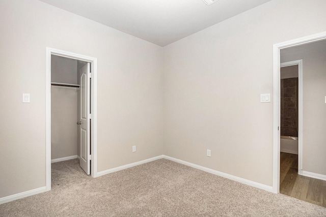 2102 Twin Lakes Blvd, West Columbia, TX 77486 - unfurnished bedroom with a spacious closet, light carpet, and a closet