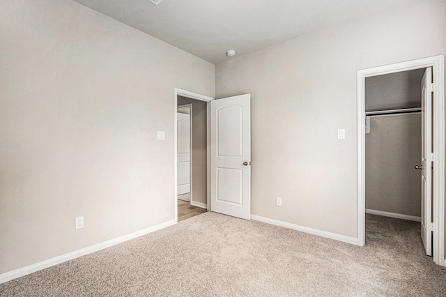 2102 Twin Lakes Blvd, West Columbia, TX 77486 - unfurnished bedroom featuring light colored carpet, a spacious closet, and a closet
