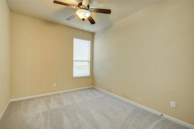 empty room with light carpet, ceiling fan, and baseboards