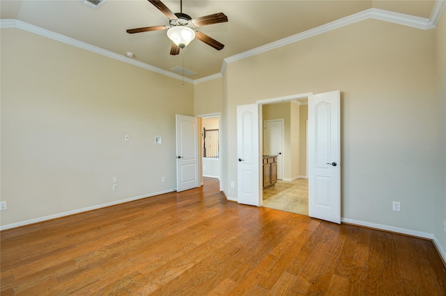 unfurnished bedroom featuring baseboards, a ceiling fan, ornamental molding, light wood-style floors, and high vaulted ceiling