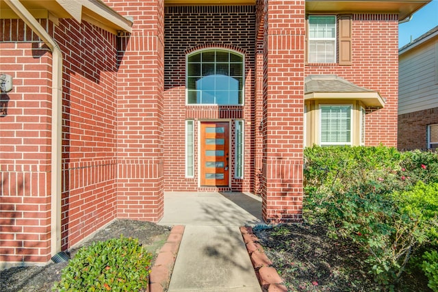 entrance to property with brick siding