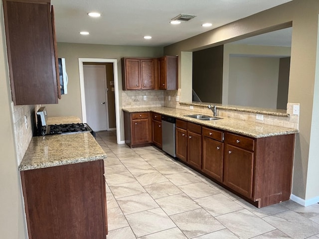 kitchen featuring light stone counters, white microwave, stove, a sink, and stainless steel dishwasher