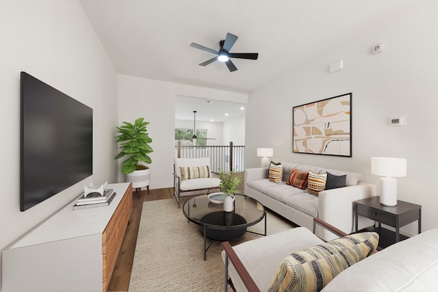 living room featuring a ceiling fan, baseboards, and wood finished floors