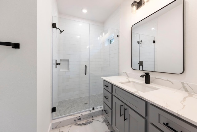 bathroom featuring marble finish floor, recessed lighting, a stall shower, and vanity