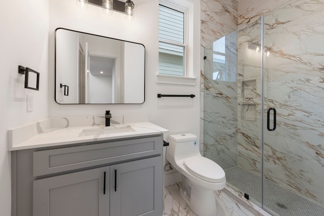 full bath with toilet, marble finish floor, a marble finish shower, and vanity