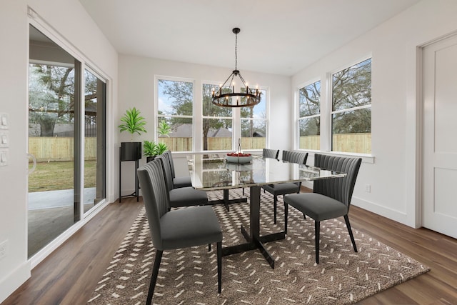 sunroom / solarium featuring a chandelier and a wealth of natural light