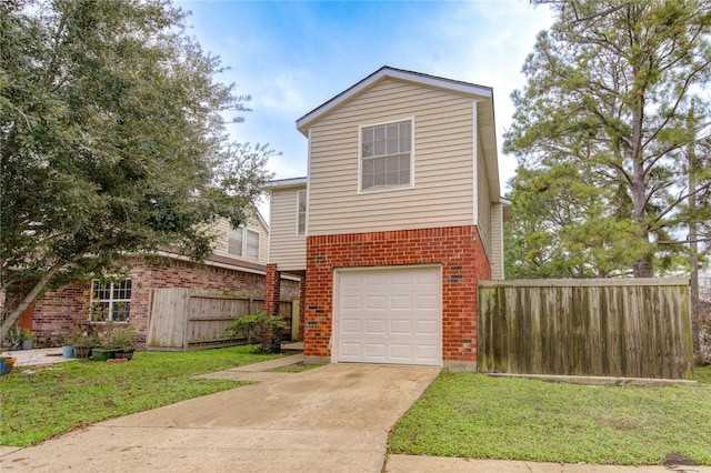 view of front of house featuring a front yard, brick siding, fence, and an attached garage