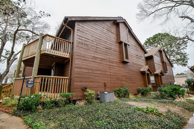 view of home's exterior featuring central air condition unit and a wooden deck