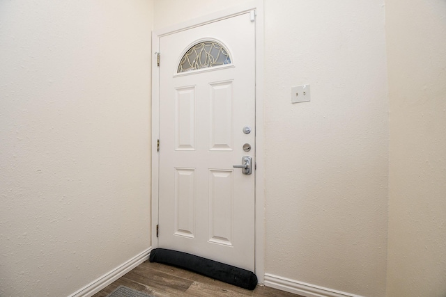 653 Davis Rd, League City, TX 77573 - doorway featuring baseboards and dark wood finished floors