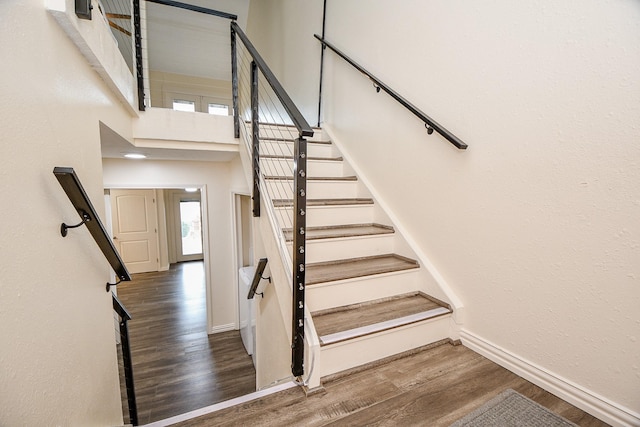 653 Davis Rd, League City, TX 77573 - stairs featuring baseboards and wood finished floors