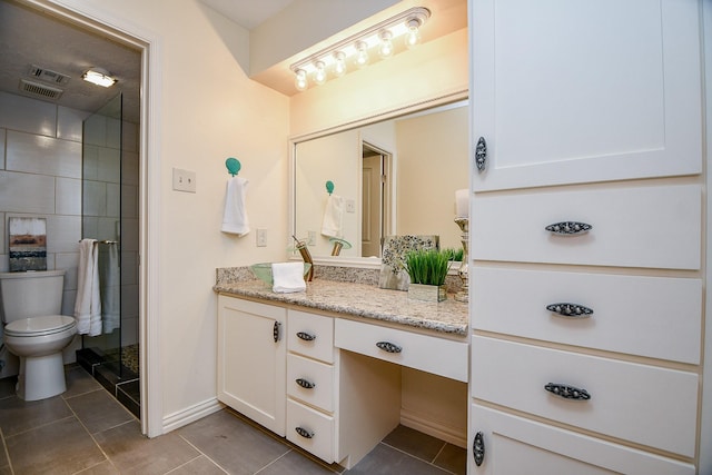 full bath featuring toilet, a stall shower, vanity, baseboards, and tile patterned floors