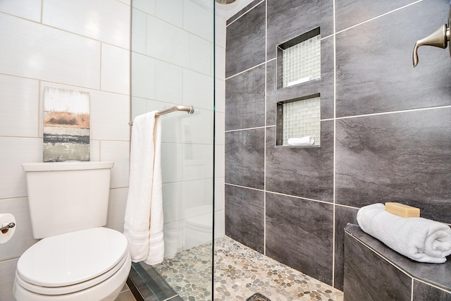653 Davis Rd, League City, TX 77573 - bathroom featuring toilet, tile walls, and walk in shower