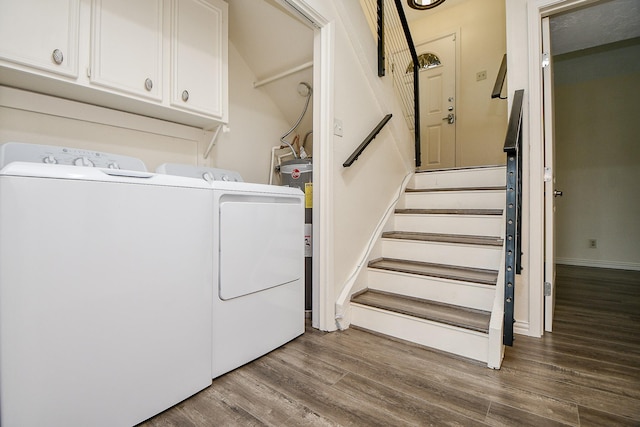 653 Davis Rd, League City, TX 77573 - laundry room featuring independent washer and dryer, wood finished floors, and cabinet space