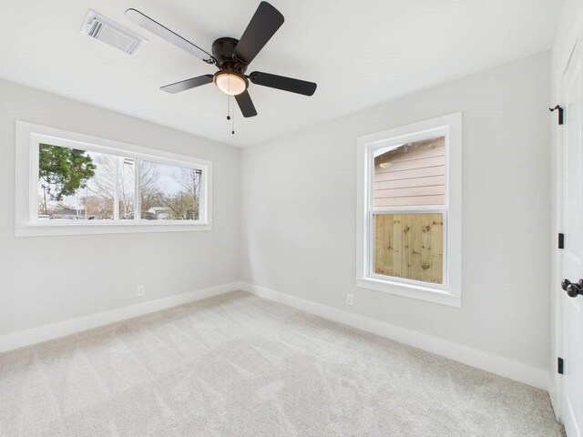 unfurnished bedroom featuring ceiling fan, carpet, visible vents, and baseboards