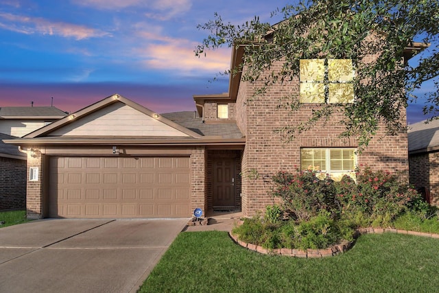 traditional-style house featuring a garage, concrete driveway, brick siding, and a front lawn