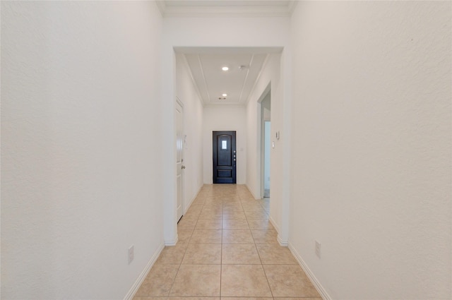 hall featuring recessed lighting, crown molding, baseboards, and light tile patterned floors