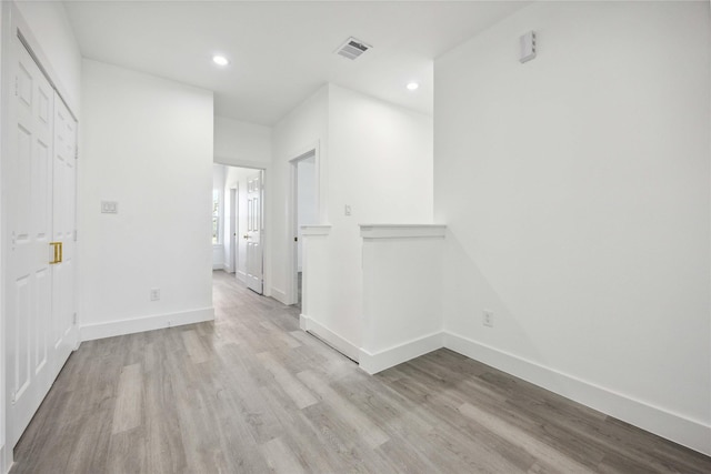 interior space featuring recessed lighting, visible vents, light wood-type flooring, and baseboards