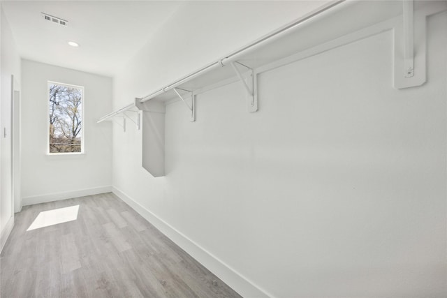 walk in closet with visible vents and light wood-style floors