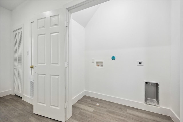 clothes washing area featuring hookup for a washing machine, wood finished floors, baseboards, hookup for an electric dryer, and laundry area