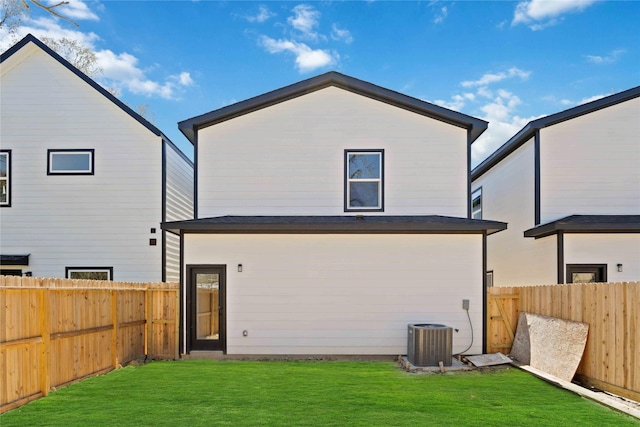 back of house with a yard, central AC unit, and a fenced backyard