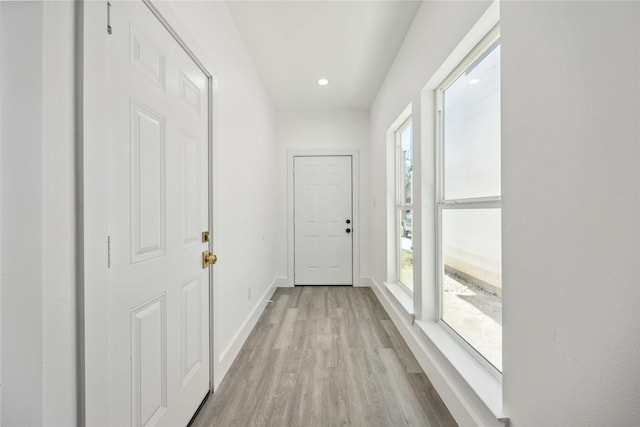 doorway to outside featuring light wood finished floors, recessed lighting, and baseboards