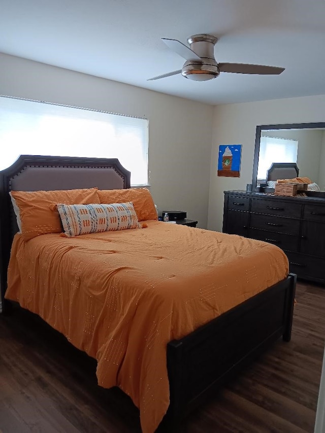 bedroom with a ceiling fan and dark wood-type flooring