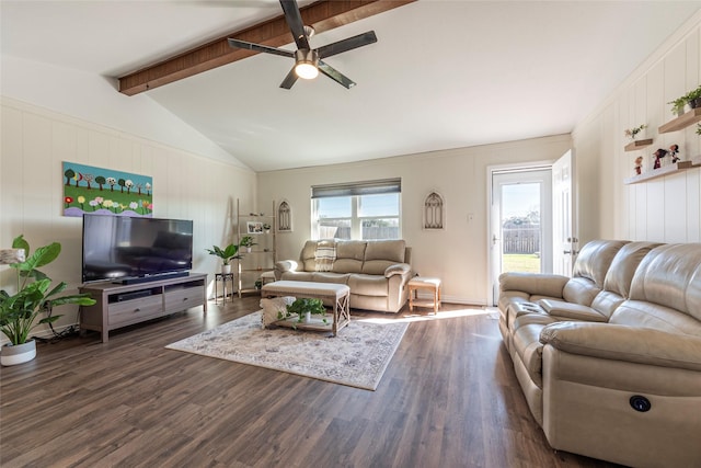 living area with vaulted ceiling with beams, a ceiling fan, dark wood-style flooring, and a wealth of natural light