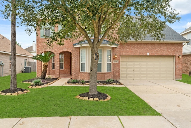 view of front of house with cooling unit, concrete driveway, brick siding, and a front yard