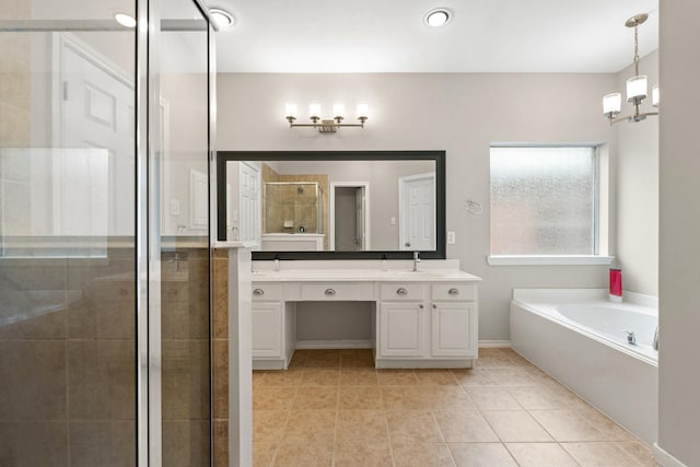 bathroom featuring a stall shower, a bath, tile patterned flooring, vanity, and a notable chandelier