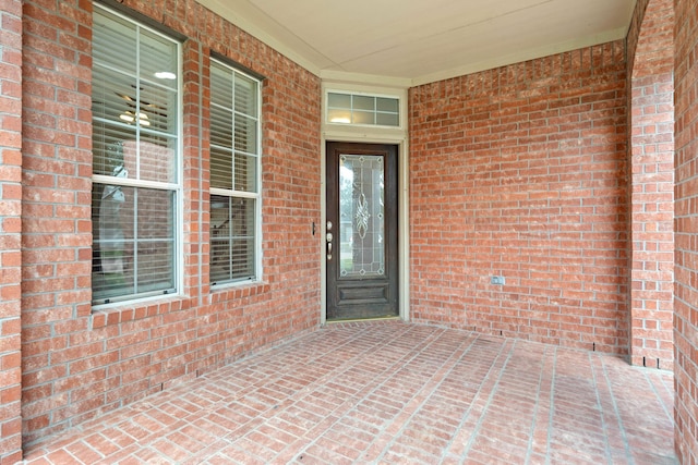 view of exterior entry with brick siding